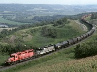Westbound mixed freight on CP's north main across the prairies climbs the grade out the Assiniboia valley near the Saskatchewan boundary. The Bredenbury subdivision has been called Manitoba's mountain railway with 3 valley crossings all with 1 pc plus grades including a 2 pc climb out of Minnedosa.