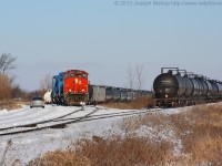 RMPX 9431 sits at Garnet Ontario on a very cold January morning.  The crew is on board on 9431 and their first move of the day will be to collect three tank cars from the wye on the other side of the concession.