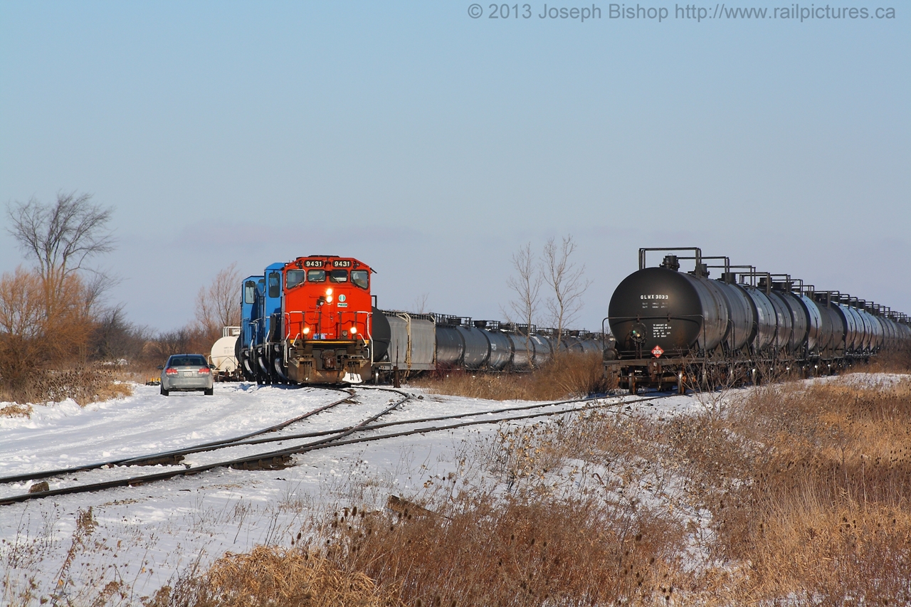 RMPX 9431 sits at Garnet Ontario on a very cold January morning.  The crew is on board on 9431 and their first move of the day will be to collect three tank cars from the wye on the other side of the concession.