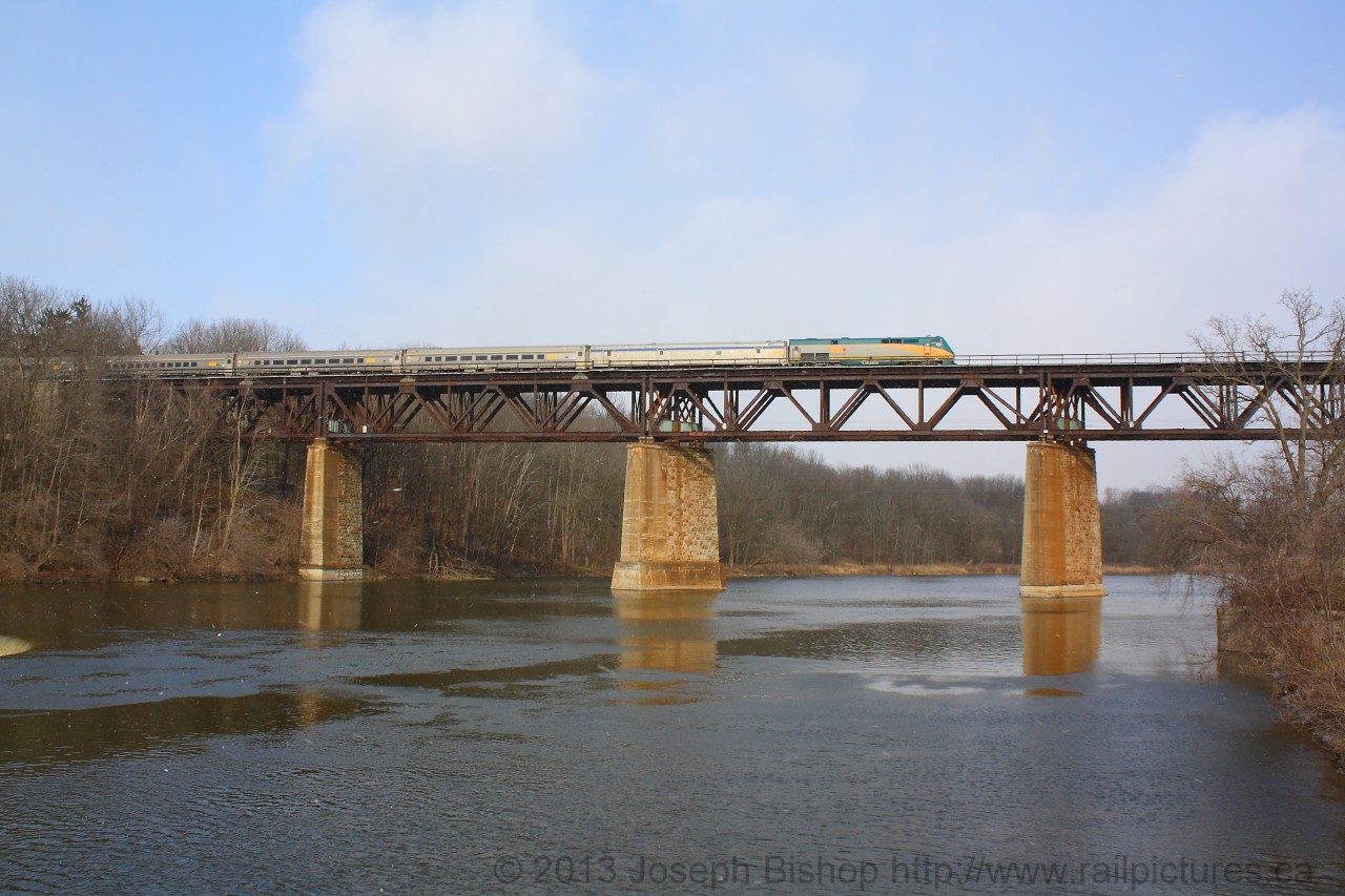 Via 72 with Via 903 on the point crosses the Grand River Bridge at Paris Ontario amid a snow flurry.