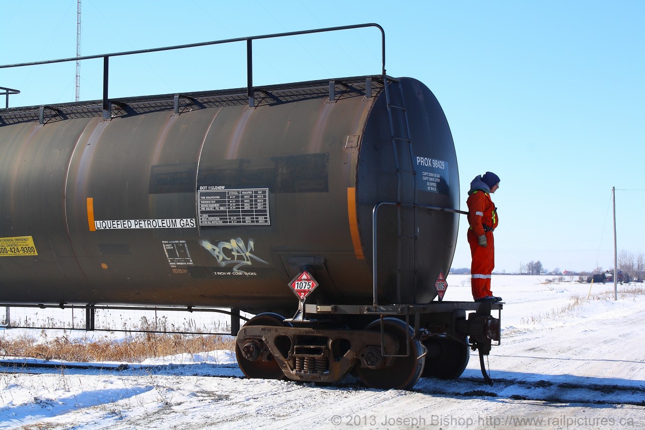 The Conductor on SOR 597 rides the end of his train in a reverse movement into the Garnet yerd.  It is a frgid morning and he will be working out in the cold for the better part of his shift.