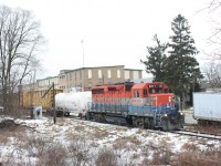 SOR GP35 #2211 rolls past the old Lens Mills factory at Hespeler on its way back to Guelph. The cut off track in the foreground was once part of the Grand River RR (CP).