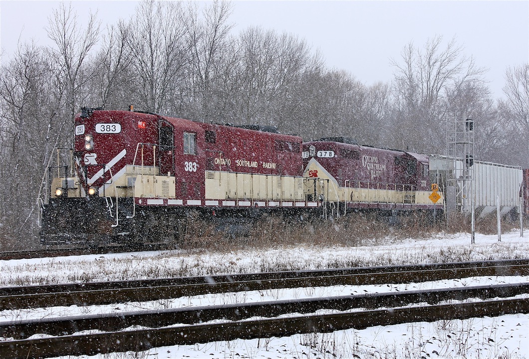After servicing the CP interchange in Woodstock the GP7 and GP9 head across the diamond at Carew in a heavy snowfall almost a year from the day this photo was posted.