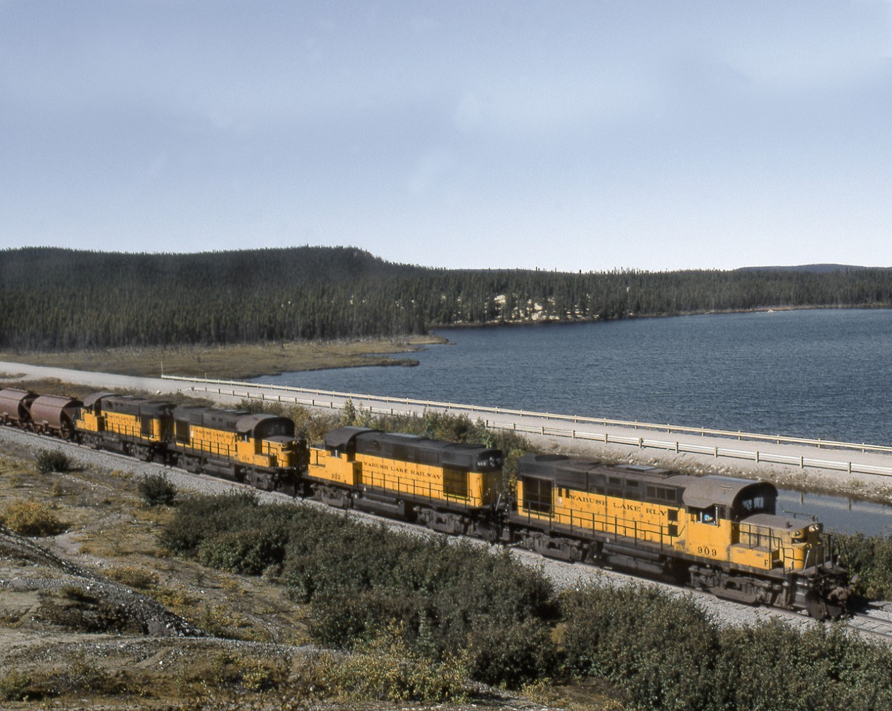 4 Wabush Lake Railway RS18's with a loaded ore train heads east on the QNSL-Wabush joint Northernland Subdivision. The Wabush will deliver the ore to Emeril Junction where QNSL power and crews will continue onto the Port at Sept Iles QC.