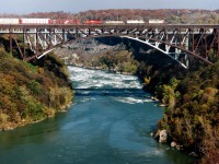 Perfect sunny afternoon as CP train #734 with SOO 789, HLCX 5007, 3105 and CP 5794 rolls over the steel arch bridge to the US of A with 57 loads and 11 empties at 1317 on a Thursday Oct. 26th, 1995.