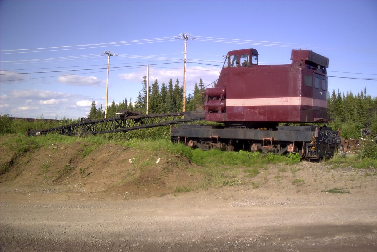 With its boom lowered to the ground, QIT's retired Ohio model DE 300 SPL locomotive crane (s/n 4825) sits idle on a deadend yard track near the Havre St-Pierre terminal.  Built in 1965, it had a long career as the ore haulers only locomotive crane.  It was replaced by a more modern, and higher capacity American model 850-80 in July of 2003.
