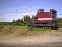 With its boom lowered to the ground, QIT's retired Ohio model DE 300 SPL locomotive crane (s/n 4825) sits idle on a deadend yard track near the Havre St-Pierre terminal.  Built in 1965, it had a long career as the ore haulers only locomotive crane.  It was replaced by a more modern, and higher capacity American model 850-80 in July of 2003.