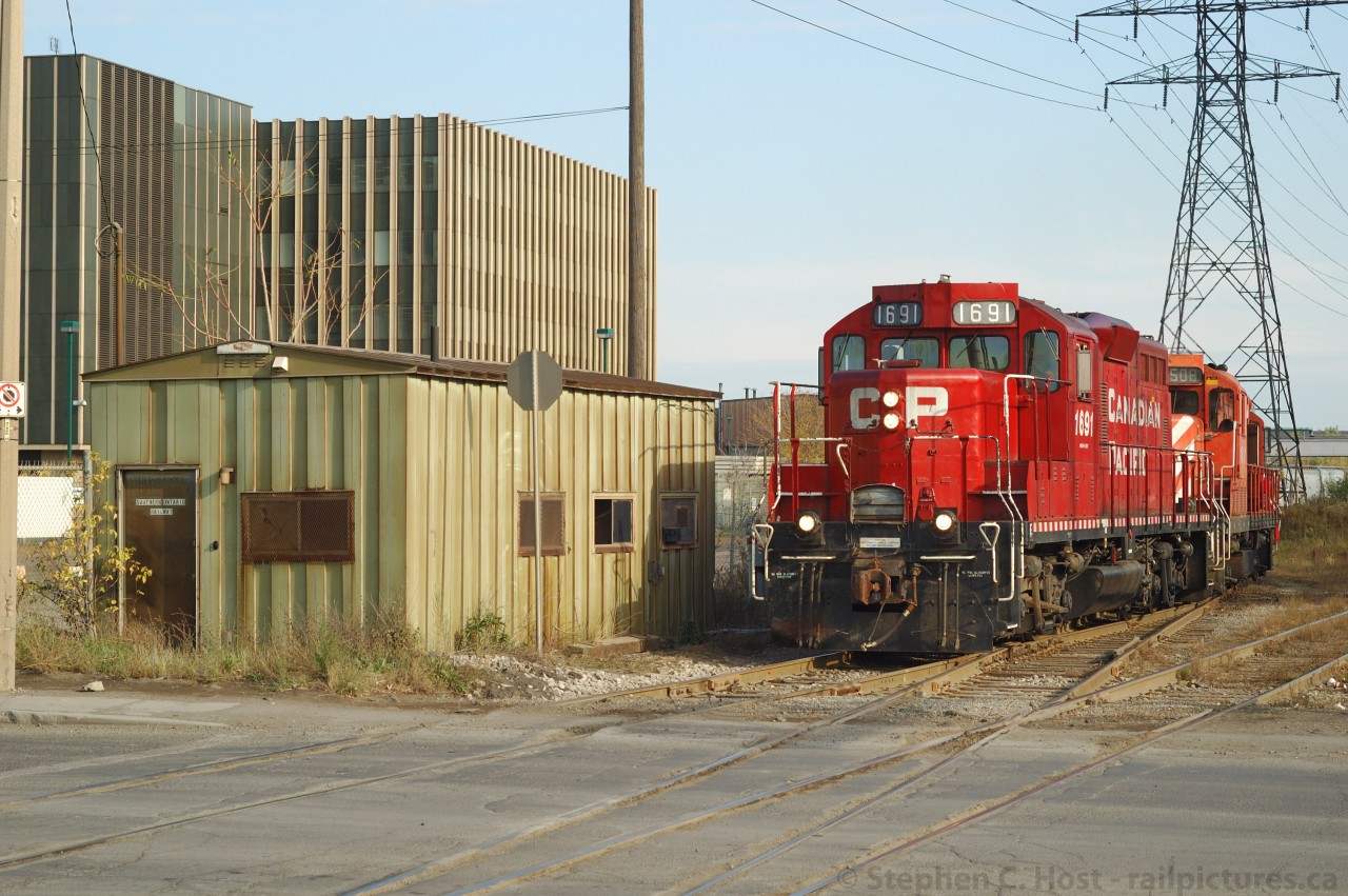 CP's Belt Line Job is about to exit the former TH&B Adams Yard (at left - 6 tracks) and head down the CP Beach Branch lead. Trackage at right is SOR N&NW Spur (formerly North & Northwestern Railway, ran to the QEW and north by the Canal to Burlington becoming what is now the Halton Sub, ran to Collingwood!). This is effectively where SOR and CP interchange cars between CP and CN for Hamilton area customers. The venerable lunch room, pictured earlier is at left. Most North Hamilton industrial trackage is actually joint track whereby customers get direct service from both railways.