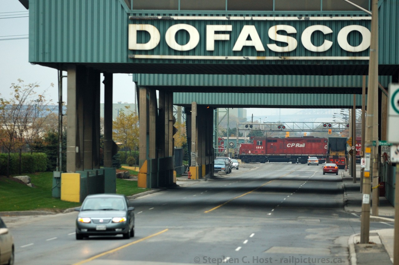 Abandon hope all ye who enter here: The menacing Dofasco Water Treatment Facility towers over Ottawa St while a Canadian Pacific Hamilton local is switching cars out of former TH&B Adams Yard. Northward beyond these gates lies the grit of Hamilton, where where steel, dust, smoke, and the most hardened Hamilton citizens live and work.