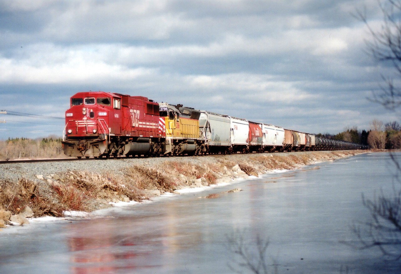 Nice sunny but cool day at the Mountsberg Reservoir to witness ethanol empties heading westbound over the causeway. SOO 6061 and CEFX 2786 for power made this train a bonus. Note general friend tacked on the head end at Welland, which was a frequent happening.  Anything to save money!! :o)