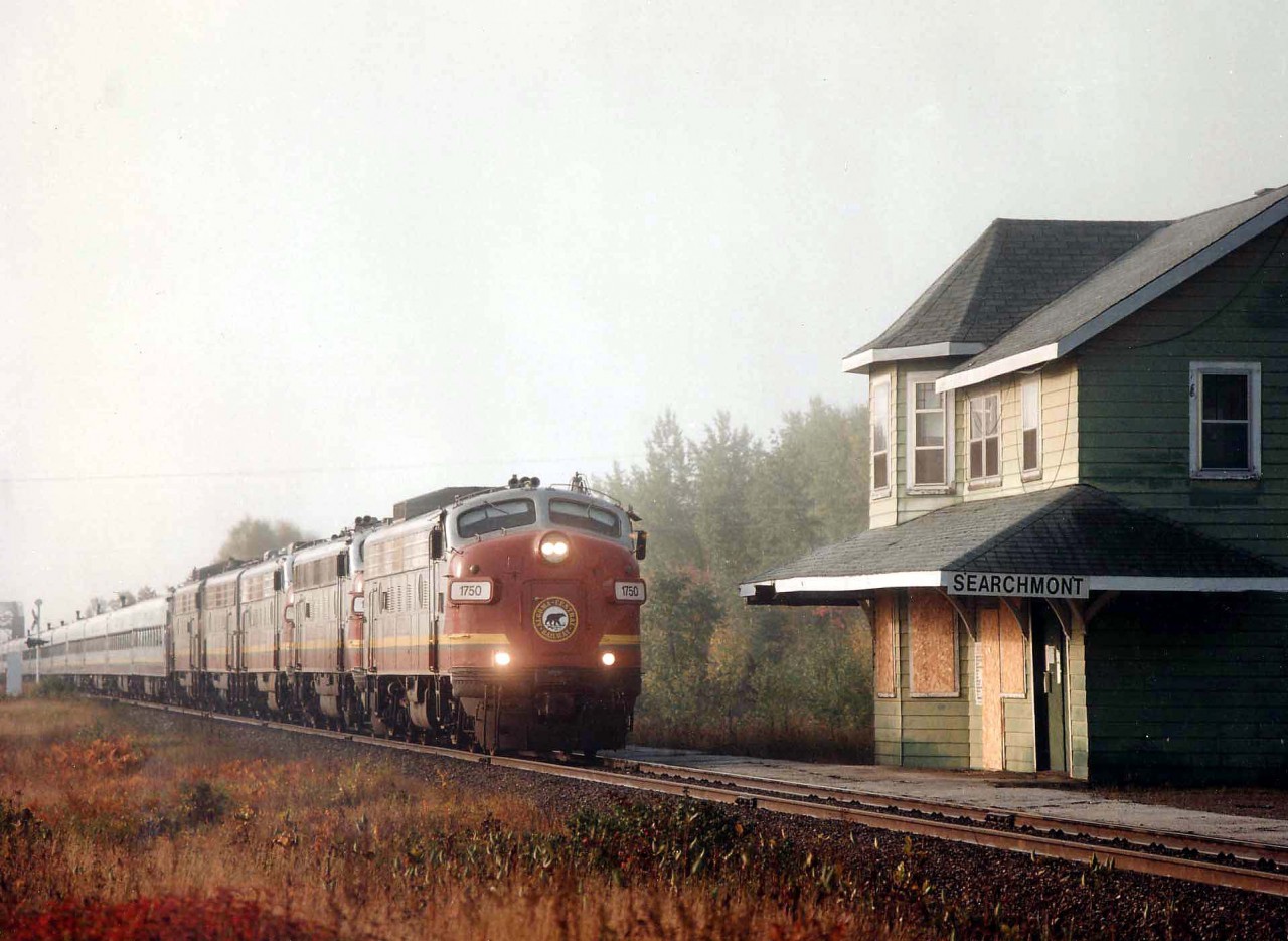 The overnight fog saved the bacon for this image of the North-bound Algoma Central Tour Train on this first of October fall morning. The train otherwise would appear almost directly out of the morning sun, making this run to Searchmont photographically a bit of a downer.  Instead, a rather nice shot of AC 1750, 1756, 1754, 1755 & 1751 with a long train rolling by the old boarded up station. AC units were formerly CN 6502, 6553(CP4103/1404) 6525, 6531 and 6506. I believe these units since have all found homes Stateside, having seen a few of them recently on the Keokuk Jct.Rwy, out of La Harpe, Ill.  I am, however, interested in the status of the old Searchmont depot.