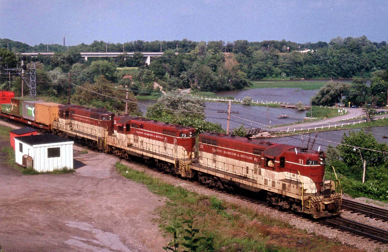 A relatively early afternoon "Starlite" thru Bayview Junction results in an all-TH&B photo free of shadow. Power is TH&B 71, 73 and 75, a matched trio of GP7 locomotives.  The #71 demo'd in a 1980 wreck, the #73 is now CP 1683 and #75 CP 1685; both based at Winnipeg and set up for remote control service.