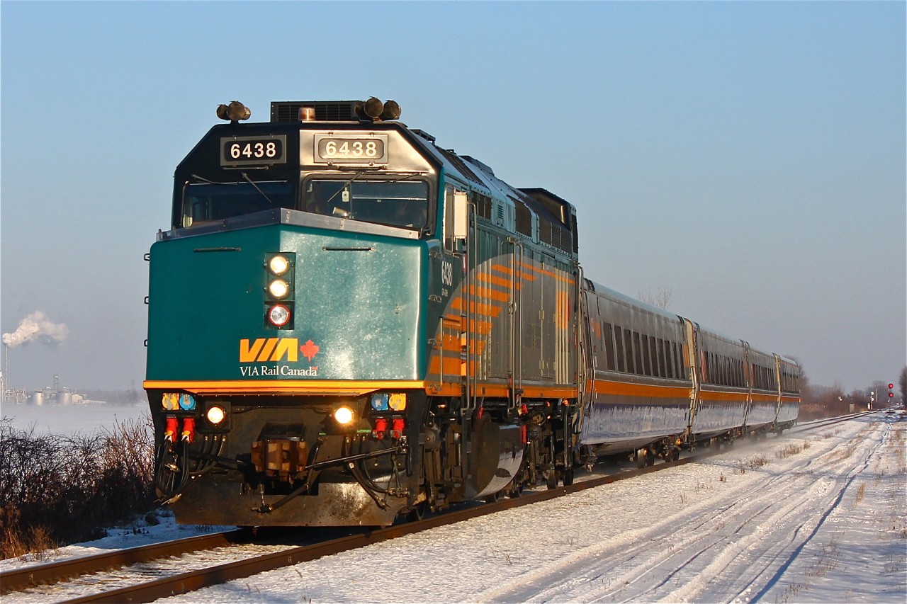 VIA 73 accelerating up to track speed (90 MPH) on the VIA Chatham Sub briefly after its station stop in Chatham. This train surprised me as I was sitting in my car to keep warm on this freezing cold day and not really paying much attention to the time and more concentrated on the scanner listening for CN 439. Grabbing my camera and running into the cold was worth it in my opinion as an F40PH-2d with LRC coaches is a personal favourite of mine.