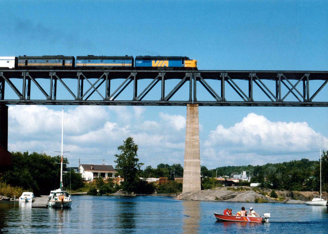 Not that often I was fortunate enough to catch an old MLW FPA-4 leading the Toronto-Bound Canadian. Seen here on a warm summer afternoon high over the Sequin River at Parry Sound harbour is VIA 6765, 6621 and 6618. Would I rather be boating?  Nah.