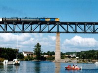 Not that often I was fortunate enough to catch an old MLW FPA-4 leading the Toronto-Bound Canadian. Seen here on a warm summer afternoon high over the Sequin River at Parry Sound harbour is VIA 6765, 6621 and 6618. Would I rather be boating?  Nah.