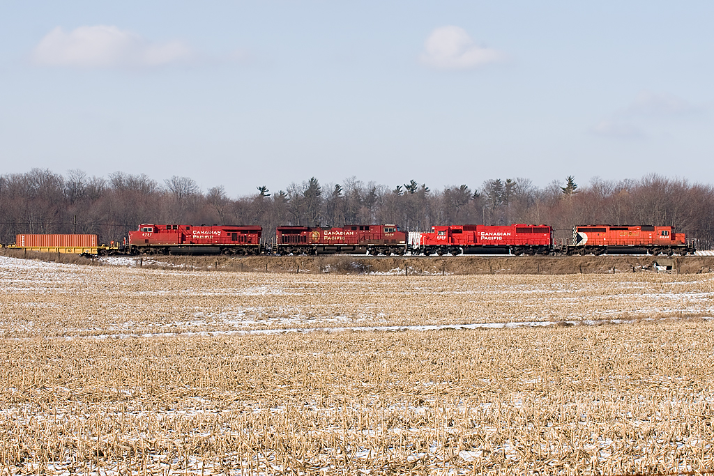 CP6048, SD60 6255, AC44 9606 and AC44 8737 reace east with solid boxes to meet Steve Host's oil train. Nice to see an SD40 still leading a hot train.