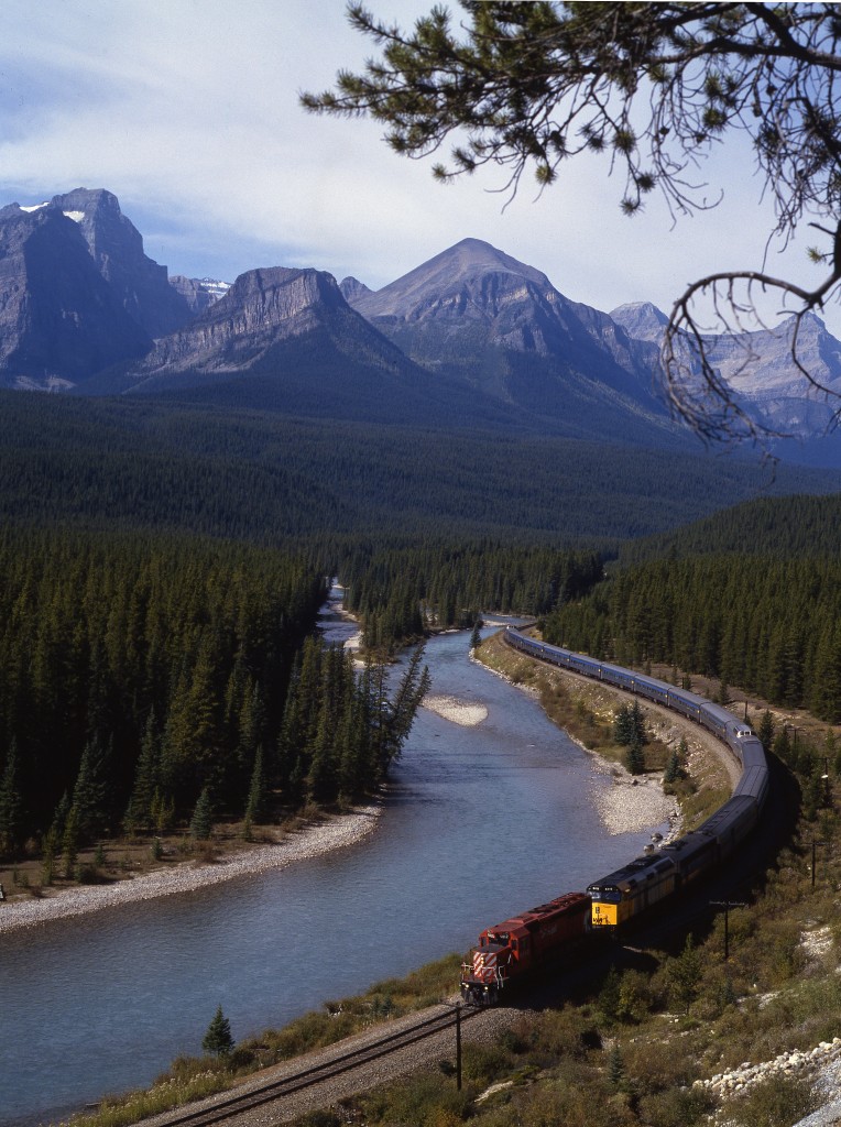 VIA Canadian has just left Lake Louise station and is heading East towards Banff. A CP SD-40-2 helper is on the point, most likely added at Field. This location is known as Morant's Curve, on Highway 1A.