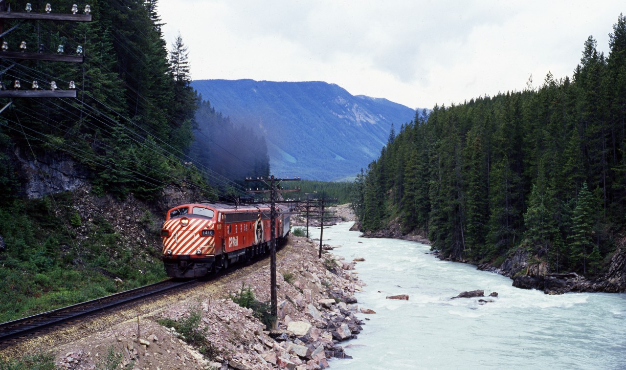CP Rail train 2, the Canadian, approaching Field BC station, running along the Kicking Horse River.