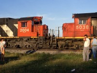 CN 207 waits for VIA 24 while the engineer and the head end brakeman and some spectators watch.