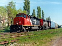 CN 105 passes as VIA 20 waits in the siding a few hundred ft from the station.