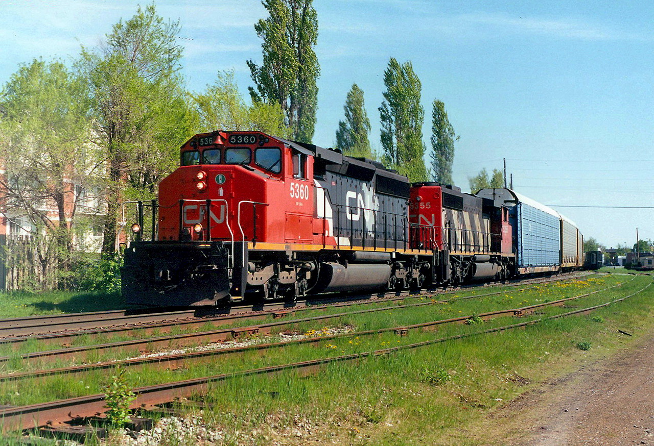 CN 105 passes as VIA 20 waits in the siding a few hundred ft from the station.