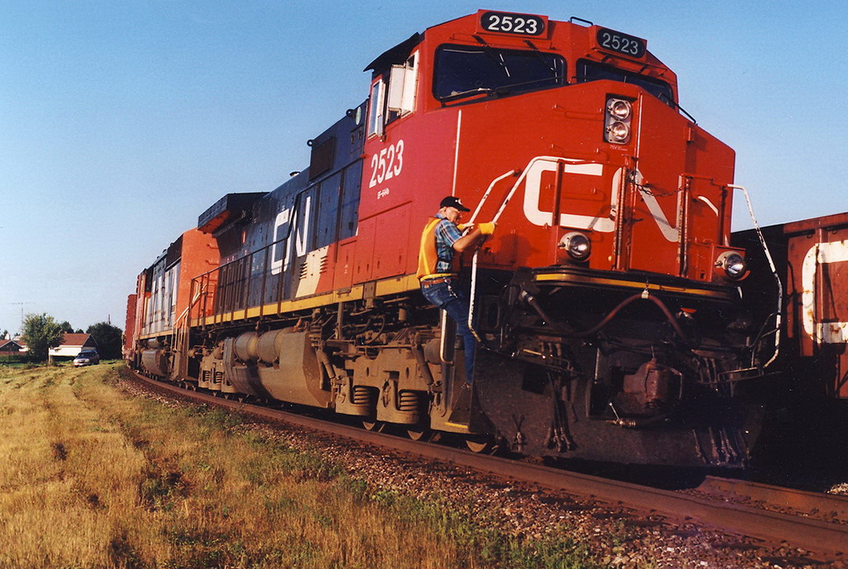 CN 305,s conductor climbs down as it comes to a stop to watch the 308 moving in the siding.