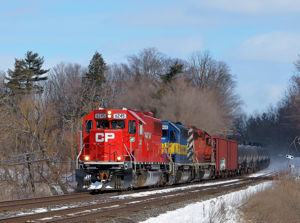 CP 609 (ethanol) is westbound on the CP Galt Sub and is just about to pass under the CN Halton Sub as it fly's through Milton on a cold but sunny February afternoon.
