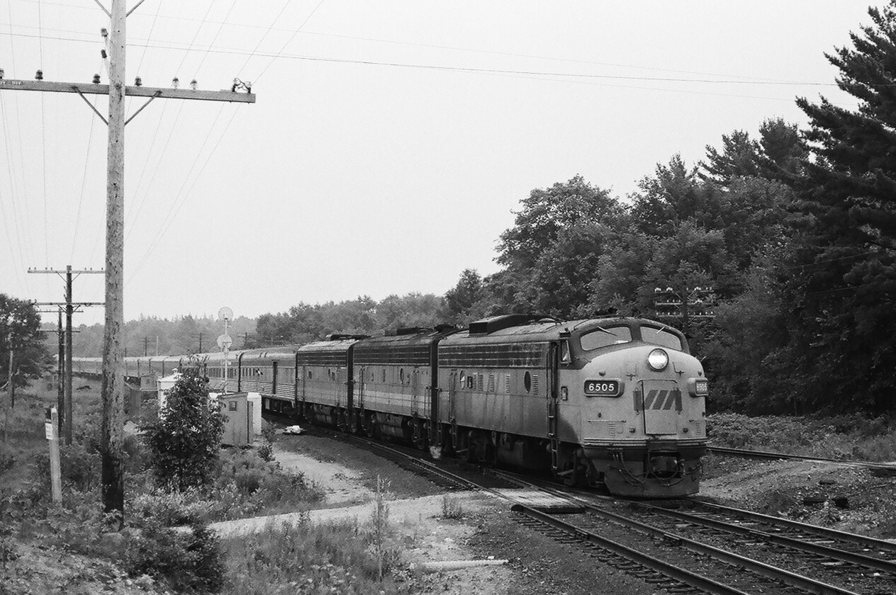 The CN Boyne – CP Rail Reynolds (mile 19.9 Parry Sound Sub) interchange commenced daily use by Via on October 29, 1978. (  I believe the interchange was put in place to accommodate Via ).  The northbound Via transcon ( westbound in Via's timetable )  train operated CN track from Toronto to Boyne (Bala Sub mile 146.1 ) then interchanged to CP Rail.  At that time to get onto CP the northbound Via  train had to back up from CN ( the CN switchpoints faced north, until sometime after 1985 ) onto the CP. Today Via operates the all CN route, except where  CN-CP Shared Asset zones exist.  In this series of three images ( in all images #9 is on CN track )  – under thundering Muskoka skies – then in a deluge  ( our campsite thoroughly soaked  at the  nearby Oastler Lake Provincial Park ),  August 10, 1985  Via Rail train # 9, powered by FP9A # 6505 and F9B  units  #6632 – 6613, pulls slowly through CN Boyne and through the south switch South Parry siding then reverses ( see    Via # 9 Glacier Park at CN Boyne    )             to the interchange switchstand where the tail end Brakeman ( riding dry in Glacier Park ) exchange the interchange switchstand key with the Trainman – then gets caught in the downpour. August 10, 1985 Kodak negatives by S.Danko. 


 What's interesting: please also see Arnold Mooney's CN Boyne image taken one week later – August 17, 1985 –  train #10 with 6505 – 6632 – 6622.

 Via # 10 at CN Boyne August 17 1985  


Most interesting: you must try camping overnight – at least once at Oastler Lake P.P., a mere 200 yards from the CN - CP mainlines – including grade crossings – even the camper's guide states  “ note railway tracks near the Park are used frequently “  . Even so, there are always camp sites available early each morning as sleepless campers leave !
sdfourty.