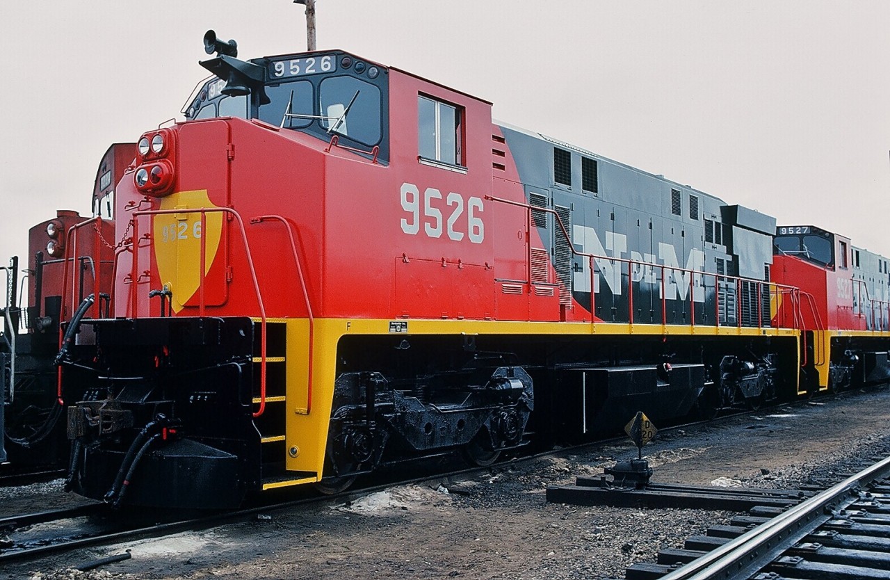 Bombardier built  Nacionales de Mexico  M424W #9526, part of order #6114 for 53 units including 9527, 9532 and 9533 (& others) in this March 1981 shipment. 
This sharp red-black-yellow paint scheme did not last, most units repainted two tone blue.
  Anyone know if some N de M  M424's operational today? 

More N de M :


  Builders' plate  

   Builders' service bulletin plate  

   #9549 June '81 image by Ron Bouwhuis'  

 CN Mac Yard. March 22, 1981, Kodachrome by S. Danko.