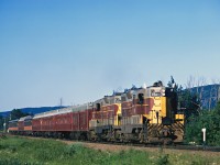 Psgr Extra 151 South has crossed the Searchmont Highway on a pleasant late July afternoon. This was the time when the Agawa Canyon Tour was becoming very popular and No. 1 and 2 had reached maximum length (about 25 or so cars total) so psgr extras were called for the overflow. Here the train has some of the so-called "Jesse James" coaches (called that account their age) as well as a couple of the ex-Central of Georgia "City of Miami" coaches and the ex IC-MOP lunch car on the tail end.

Back then no one minded people standing in the vestibules...try that today on the sanitized and sealed tour train :).

Soon the Agawa Canyon Tour would be operated as a Canyon Turn running as Second Class Passenger Trains No. 3 and No. 4.

The 151 is still in service today working a grain elevator in Saginaw, Texas. Link to the photo on my web site:

http://algomacentral.railfan.net/images/AlgoCenRy/ATTX_151_Saginaw_Texas_10-14-2011_Randy_Faris.jpg