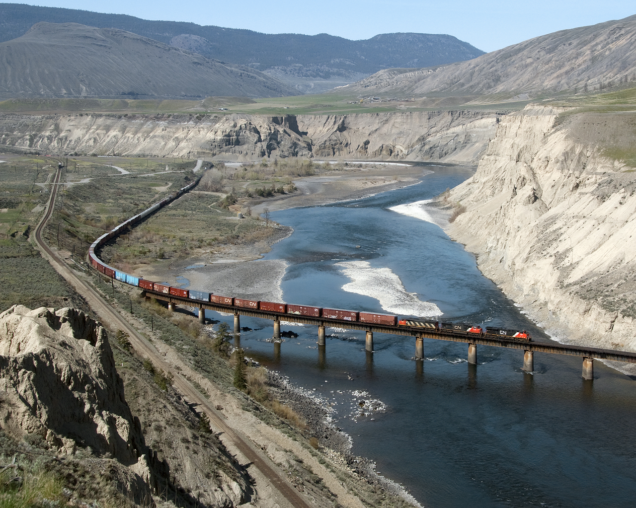 Eastbound CN 416 intermediate traffic Vancouber to Edmonton crosses the Thompson River just east of Ashcroft. CP Main is on the left