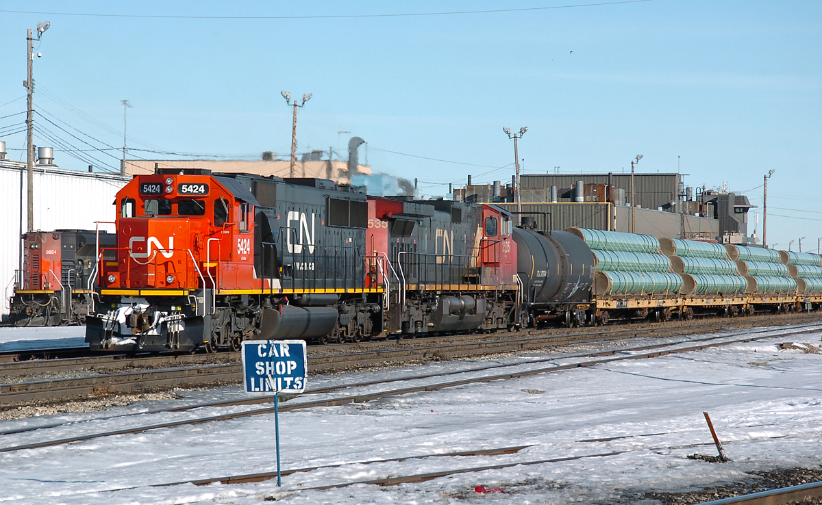One of CN's shiny "new" ex-Oakway SD60s leads an almost entirely pipe train West out of Walker yard.