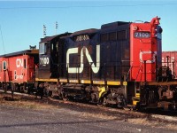 The first of the "Sweeps", CN #7100 sits awaiting next assignment in the diminutive yard off the Grimsby sub at mile 9.49. These unusual appearing locomotives are actually an SW1200RS switcher in a GP 9 shell, remanufactured with GP main generators, cooling fans and other such parts mated with the SWs, resulting in a model known as SW1200RM. The production took place at Pointe St. Charles main shops in the mid-'80s, and the units were sold off to CANAC in 2000. Seeing only eight (7100-7107) of these creatures were created, this was a rather rare bird.