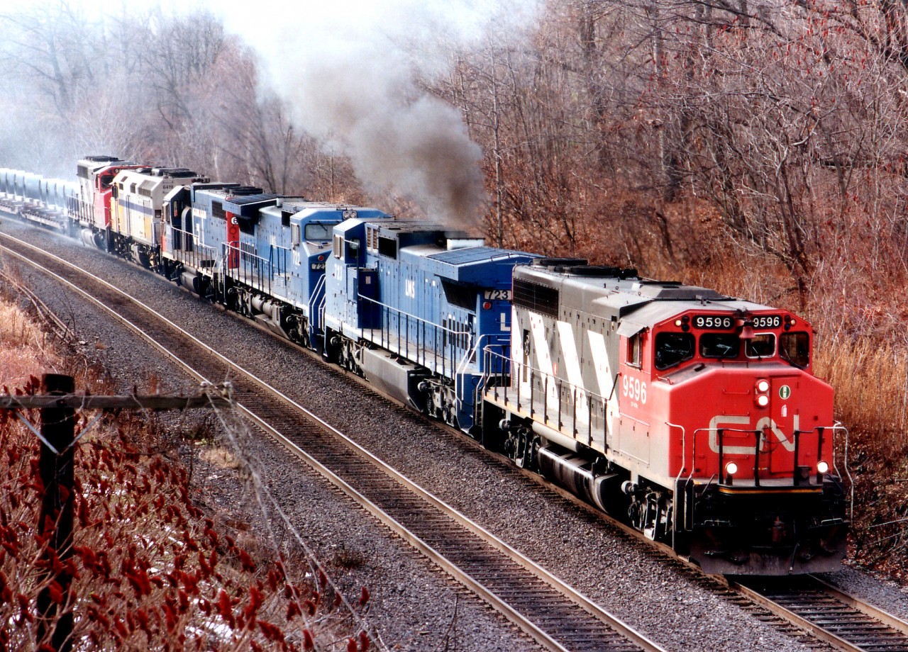 Back in the mid-90s the CP wasn't the only road to serve up surprise lashups.  Here, we see CN's #410 coming east around the bend approaching the roadbridge now known as "Snake" (but was Bayview E in my notes back then)with a colourful lashup complete with a smoky turbo.  CN 9596, LMS 723, 222, GT 6216, VIA 6419 and CN 9431 make for an interesting sighting on an otherwise typical dull grey December day.