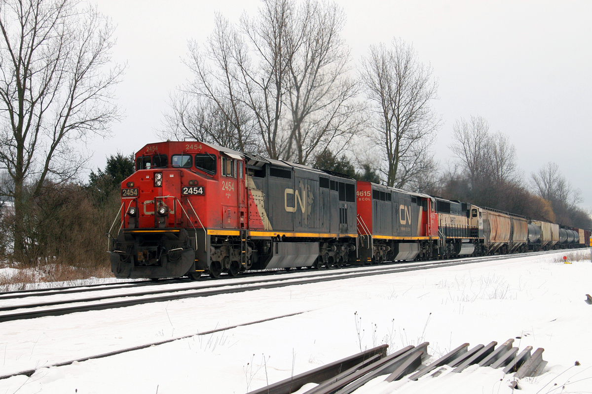 CN 397 had a rare visitor to Ontario on Feb 11, 2013 as seen here at Copetown, ON.  
The 2454 was followed by BCOL 4615 and BNSF 9607 in the Exectutive paint scheme.  
It has been quite some time since we have seen BNSF visitors on the Dundas Sub. 
Unfortunately, 397 came along just before a short cloudburst.  The sun would poke out a few minutes later.