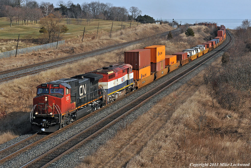 Starting into the climb to Newtonville, CN 2627 and BCOL4605 lead 149's train west just outside Port Hope. 1337hrs.
