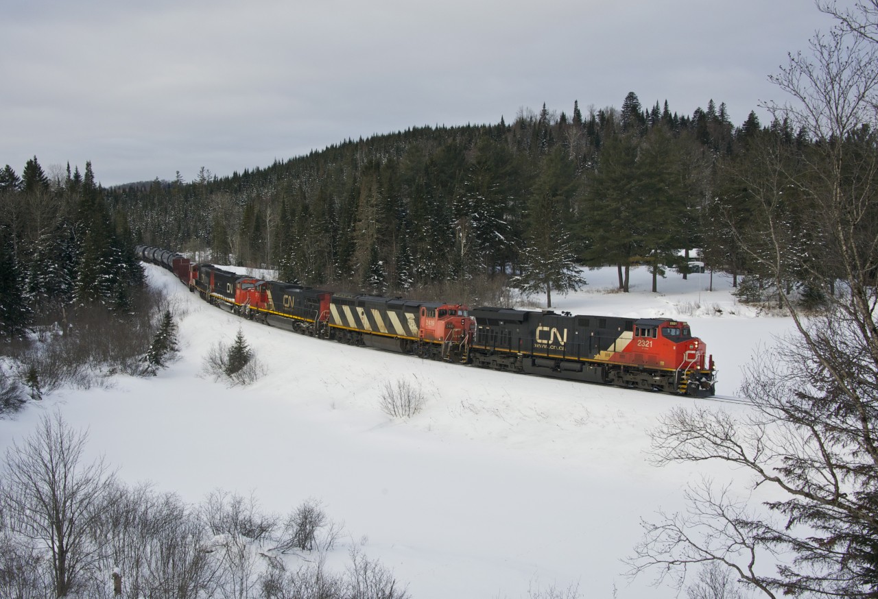 On a cold sunday morning in northern Quebec, CN 368 round another curve on the Lac St-Jean subdivision bound for Chambord,Qc and a connexion with Roberval & Sagueany Ry. For the record, consist include ES44DC 2321, C40-8M 2419, IC C44-9W 2717, CN SD70I 5625 and SD75I 5755. Out of view and working mid-train was C44-9W 2203.