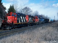 I wasn't foaming this day, but for whatever reason had the scanner on and heard that train 335 (Garneau, PQ. to Buffalo, NY) had stalled on the 'Scarborough Hill'. It took a little while to get down to the tracks, but when I did was greeted with a unusual sight in the diesel era; headend helpers. Though helpers were most common here in the steam era from Don Yards as far as Port Union, a combination of better low speed pulling power of the diesel and the re-routing of most freights away from downtown via the York and Halton Subs had made this non-existant. Usually a heavy train with a good amout of steel out of Hawkesbury, it would seem that this 335 was too much for CN 6027 and CR 6666 to get over the hump, so 546's power, CN 4115 and 4101, came to the rescue. And yes, it sounded great! 1329hrs.