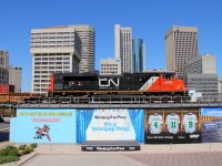 CN 8896 brings up the rear of Q101 as it passes through the city.