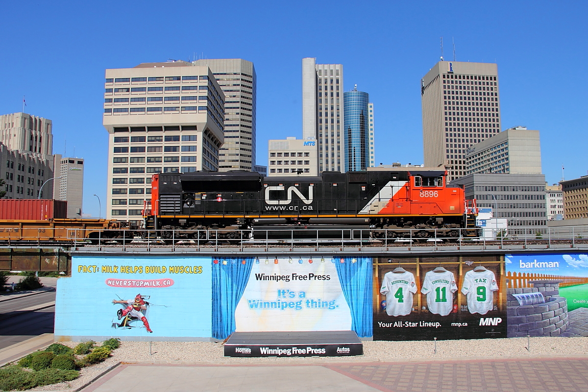 CN 8896 brings up the rear of Q101 as it passes through the city.