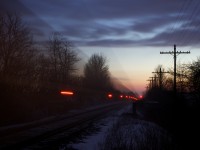 Canadian Pacific's Montreal to Chicago hotshot train # 143 streaks along the Galt Subdivision and up the grade at Puslinch on a frigid February evening.