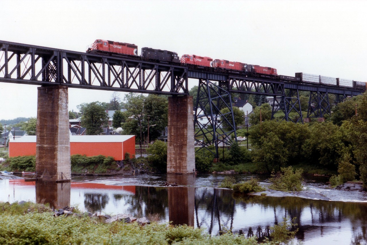 After setting off a couple of tank cars at the diminutive yard in Parry Sound, CP train #912 heads south over the big Sequin River trestle. Power is CP 5519, CR 7793, CP 3073, 4715 and 4570 on a rather gloomy and dull afternoon.