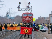 Protestors hold up a Westbound CP train while making a stand about GE-Hitachi's uranium processing plant which has been in the neighbourhood for 50 years at Landsdowne and Brandon. 