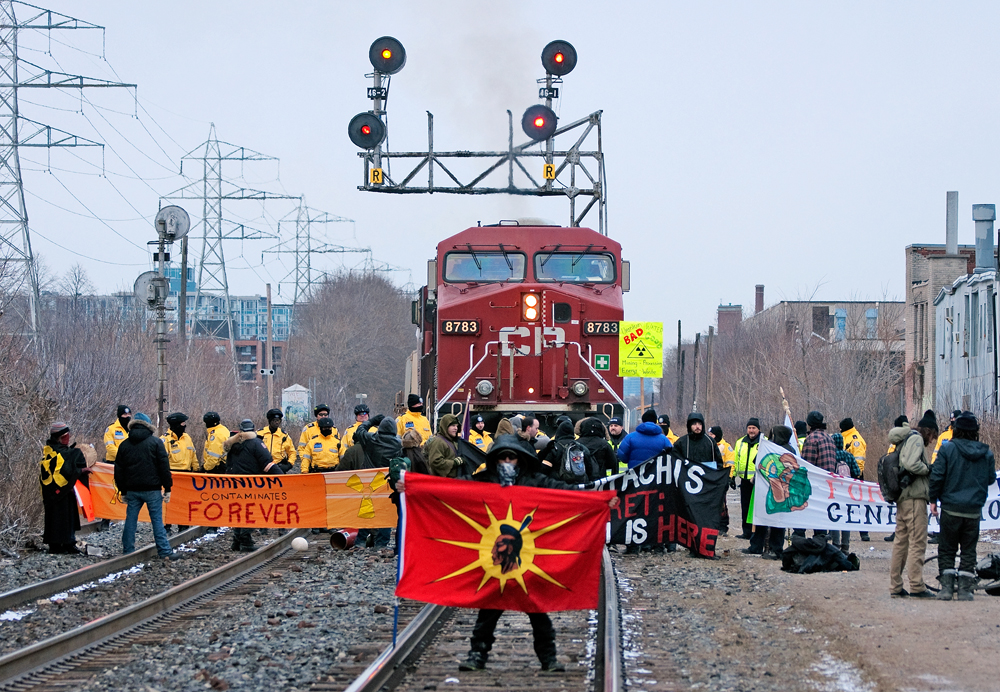 Protestors hold up a Westbound CP train while making a stand about GE-Hitachi's uranium processing plant which has been in the neighbourhood for 50 years at Landsdowne and Brandon.