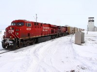 A westbound intermodal passes the prairie skyscaper at Meadows.