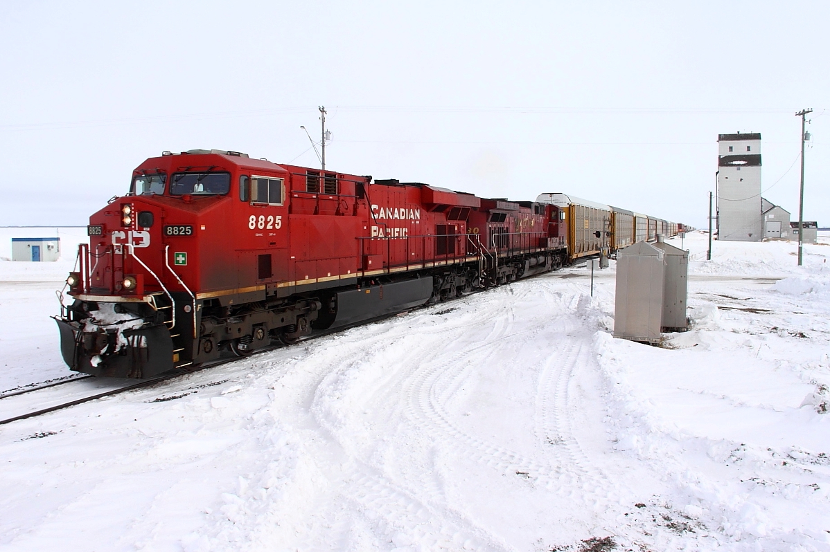 A westbound intermodal passes the prairie skyscaper at Meadows.