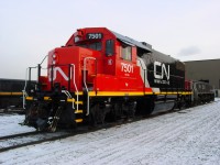 [Editors note:  Accepted due to location and rarity of access] Freshly shopped and painted CN GP38-2 7501 sits in the fading sun at Mac Yard. Note small logo under 7501 says Transcona 100 years 1912-2012