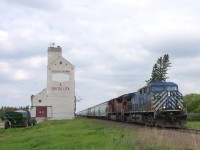 On my spring 2011 trip to the prairies, a major goal was to capture the quintessential prairie scene of a train passing a grain elevator. These iconic buildings are becoming more and more of a rarity so this was more difficult to accomplish than I had expected. Of course, my luck would have it that on my day dedicated to all things rail, storms would thwart my attempt at seeing small, light clouds float over the endless prairie, and a leased unit would be on the point of the only train we saw while it wasn't raining. The only consolation? The trailing unit, CP 9103 is now off the roster pending sale.