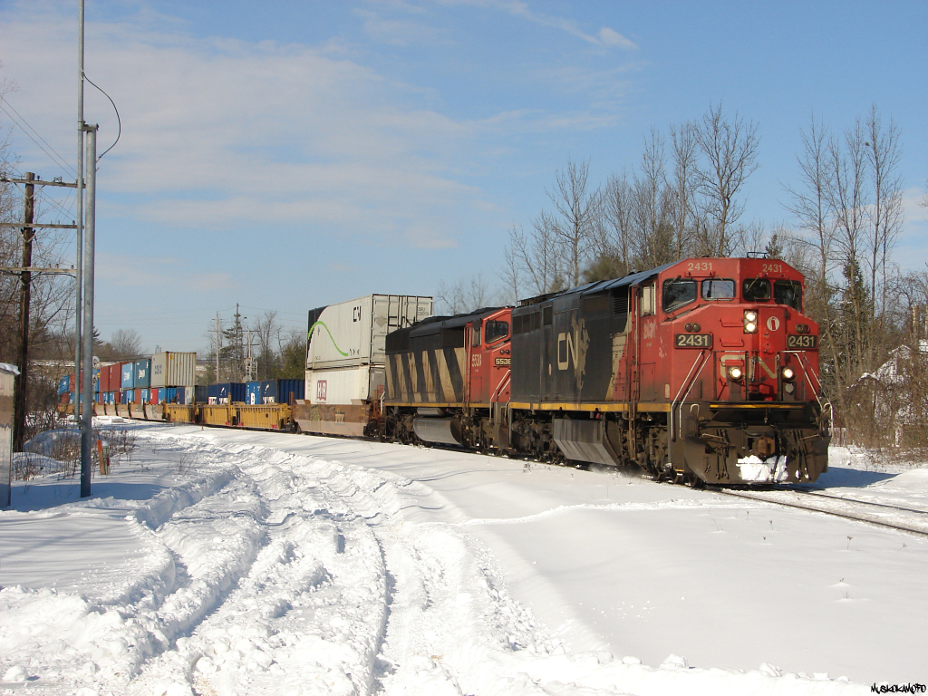 CN X10450 05 - CN 2440 South make's it's way through Washago heading down to Smail to hold back clear of any crossings while CN 101 and 190 get walked over a broken rail (5 MPH) down at the South end of Brechin East further ahed. Once 101 was clear and 190 had started to pull, X104 would make it's way down to tuck into the Siding at Brechin East and follow 190's slow path. Interestingly enough, 190 and X104 had been within about 35 mins of each other since originating in BC on Feb 5th! Precision railroading at it's finest!