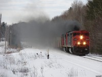 CN M31641 08 - CN 2454 South hacks and coughs her way through Sparrow Lake heading to Smail to meet train 103. Through all that smoke is a train of frozen ballast loads from Milnet, loaded tanks for Nanticoke, some mixed freight and a big cut of empty multis for Southern Ontario. 
